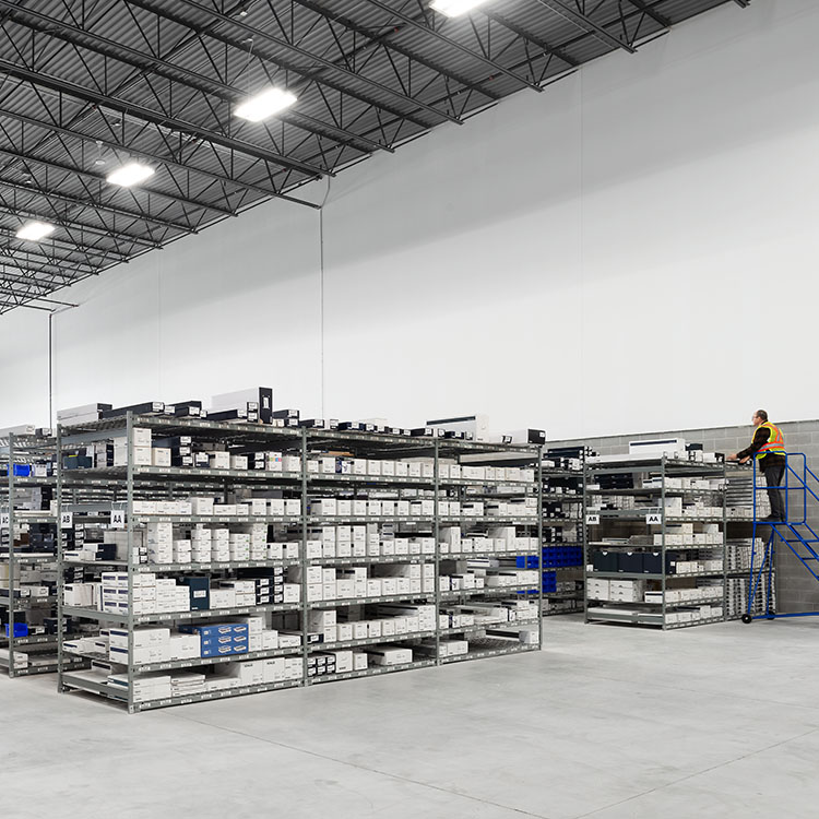 Widespan bulk high bay shelving accessible with rolling ladder